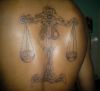 libra tattoo on back of man